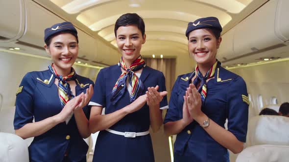 Cabin Crew Clapping Hands in Airplane