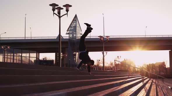 Businessman in Jacket and Tie Walks Down Stairs in Handstand