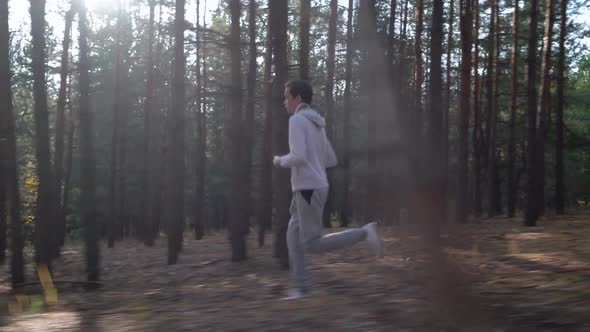 Teen Sprinting on the Pine Forest