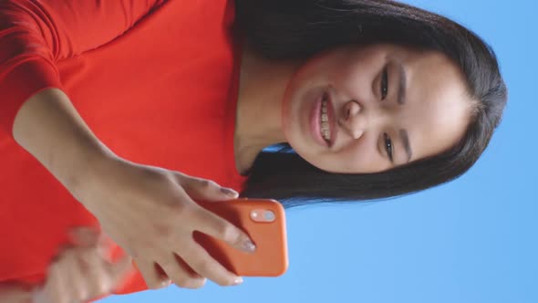 Young Woman Video Chatting with Smartphone