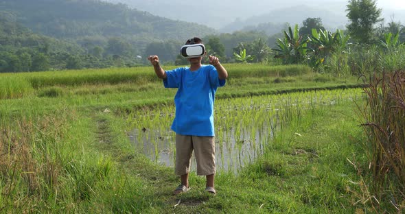 Rural Little Boy Using VR Goggles Device For Mobiles alt