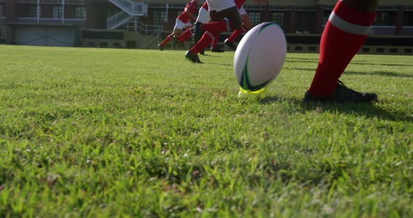 Rugby player kicking the ball from the kicking tee in the stadium 4k