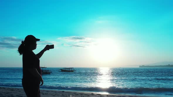 Beautiful smiling girl travelling enjoying life on beach on sunny blue and white sand 4K background