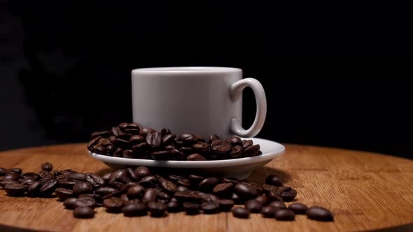 White mug with coffee on a saucer on a wooden background