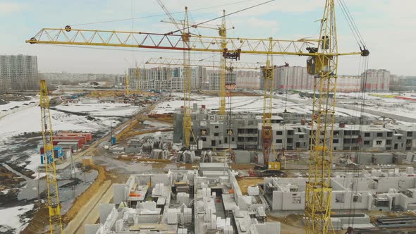 Motion Above Construction Site with Huge Yellow Cranes