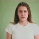 Disgusted Blonde Lady in White Tshirt Narrows Eyes on Green - VideoHive Item for Sale