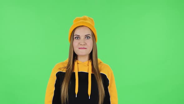 Portrait of Modern Girl in Yellow Hat Very Upset and Saying Oh My God. Green Screen