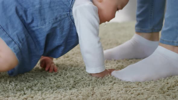 Dribbling Baby Girl Crawling Towards Mother