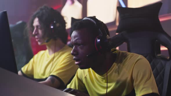 African American Gamer Speaking with Teammates During Match