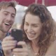 Couple looking at smart phone together - VideoHive Item for Sale