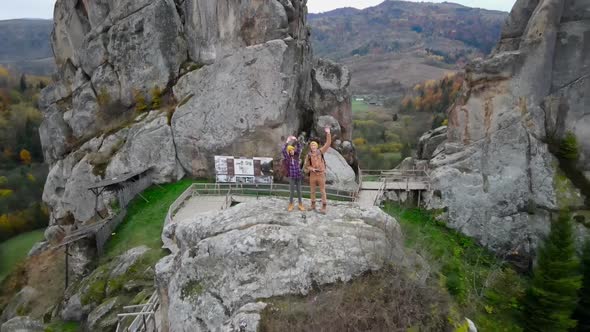 Aerial Happy Smiling Couple Hiker Walks Together in National Park Tustan in Ukraine