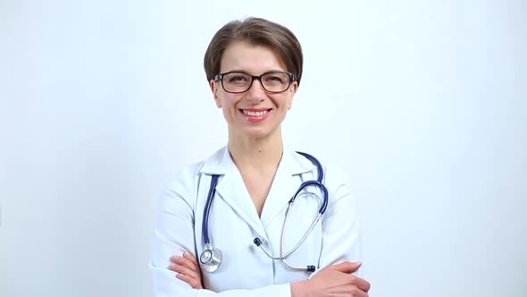 Portrait of a smiling female doctor on a white background.