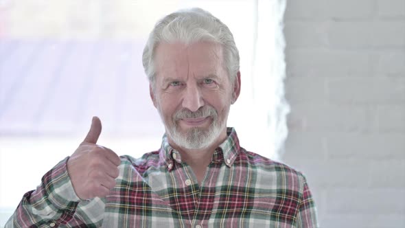 Portrait of Thumbs Up By Casual Old Man