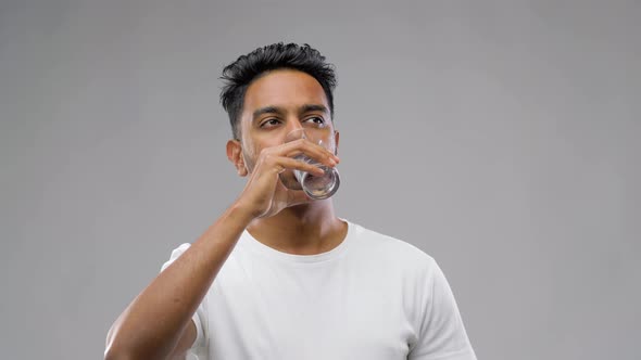 Happy Young Indian Man Drinking Water From Glass 37