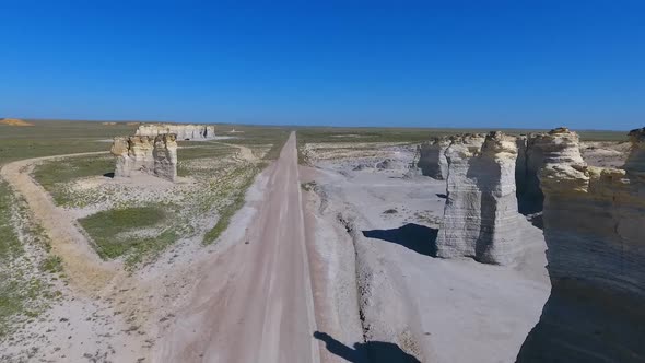 Aerial Over Desert Road with Pillars of Rock