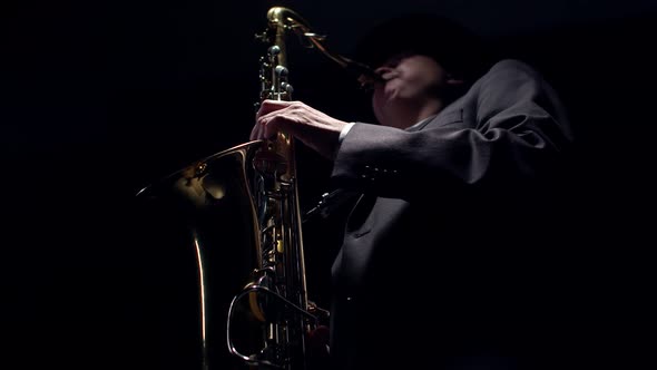Artist Presses the Saxophone Valves with Fingers Closeup