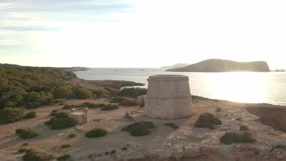 Pirate lookout tower in Ibiza, panning around while moving down. Showing the tower, ocean, islands a