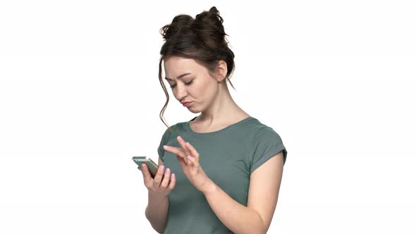 Portrait of Happy Caucasian Woman 20s Wearing Casual Clothing Holding Smartphone and Scrolling Feed