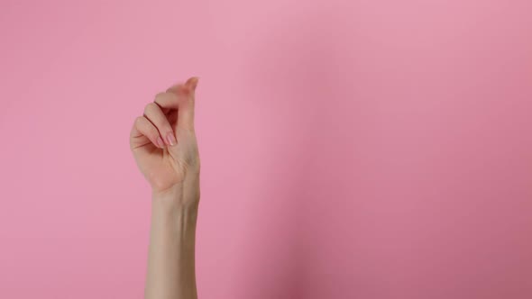 A woman's hand shows a monetary gesture. Pink background