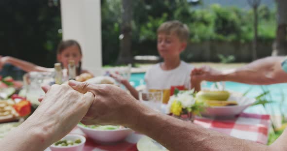 Happy family eating together at table