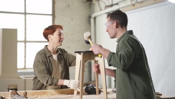 Team Work of Two Caucasian Joiners Working in Workshop Together Carpentry Concept