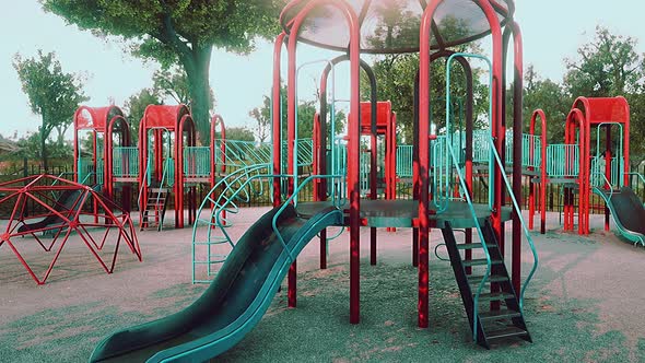 Empty Swings on Summer Kids Playground