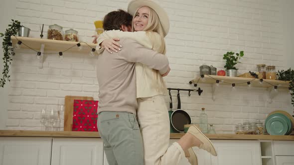 Happy Caucasian Longhaired Blonde Girlfriend is Held Up By Her Partner While Celebrating Valentine's