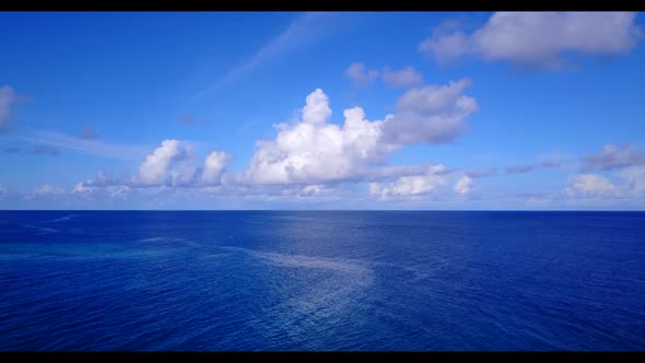 Aerial above sky of perfect lagoon beach break by turquoise ocean with clean sandy background of a d