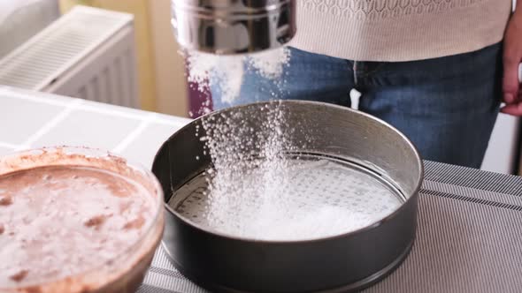 Closeup of Bakery Concept  Woman Flouring a Baking Dish for a Cake