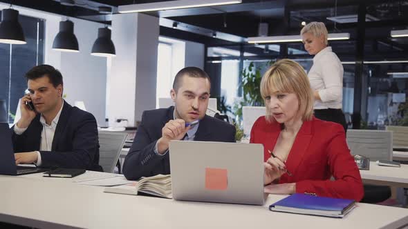 Woman and Man Talking and Using Personal Computer with Internet