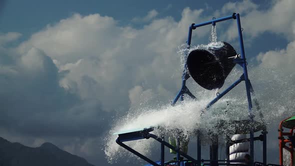 Water Park a Bucket of Water Turns Over. Slow Motion. Close Up