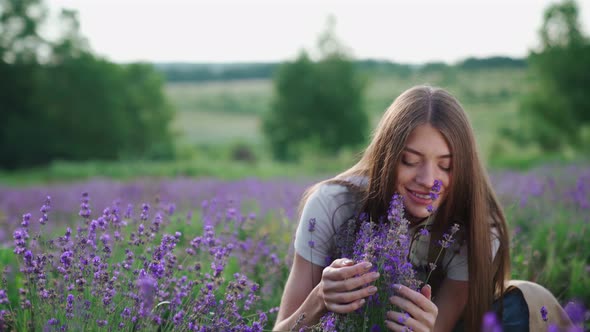 Smiling Woman Smelling Scent in Lavender Field