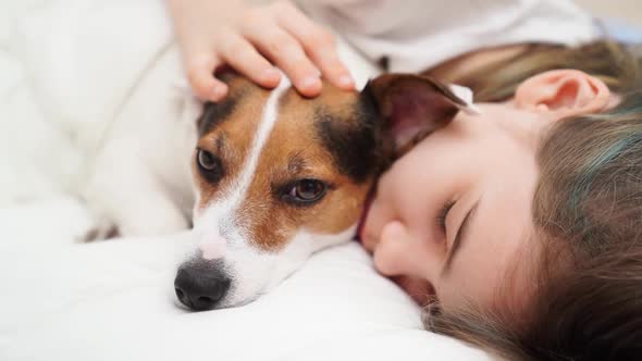 A Teenage Girl Sleeps with Her Dog in Bed