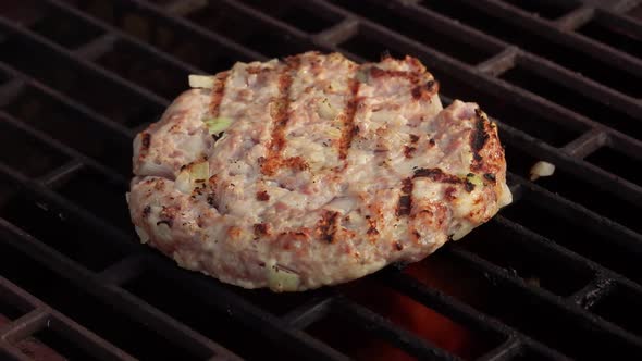 Closeup of Delicious Burger Cutlet Made of Meat and Onions Roasting on a Grill