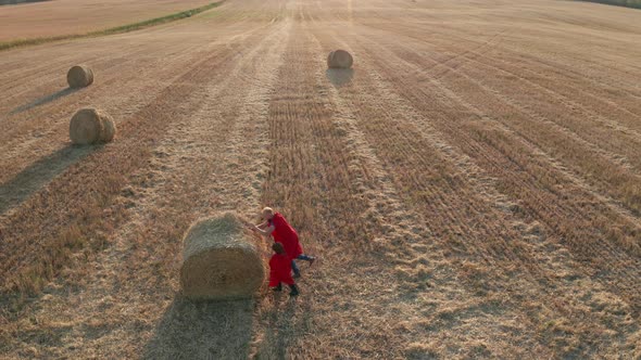 Drone View of Superheroes Rolling Huge Straw Stack