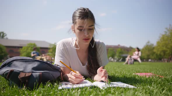 Portrait of Female Student in Earphones Study Online Outdoors