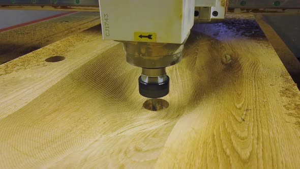 Wood milling machine cutting out sinkhole for oak wooden sink.