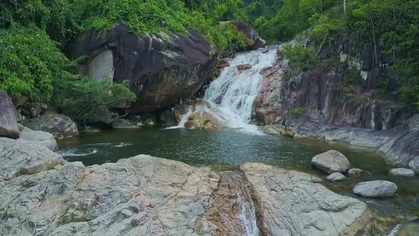 Aerial View Blue Pond Among Rocks and Waterfall in Jungle