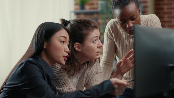 Software Engineer Pointing at Computer Screen Explaining Running Code to Coworkers Brainstorming