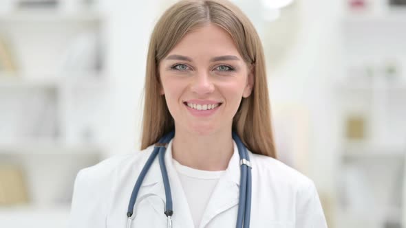 Portrait of Cheerful Young Doctor Smiling at the Camera