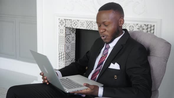 Young Successful African Businessman Celebrate Victory Look at Laptop Winning Lottery