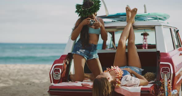 Girls taking pictures in vintage car