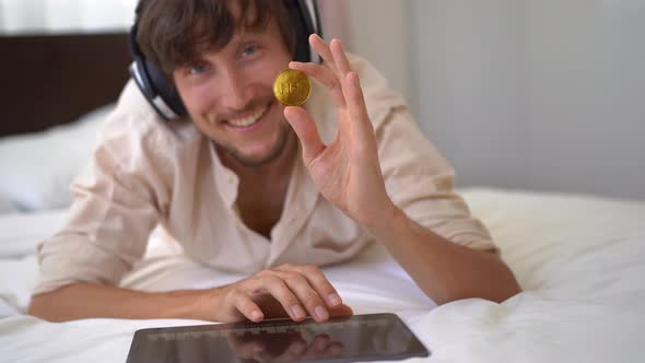 A Man a Music DJ Holds an NFT Coin in His Hand