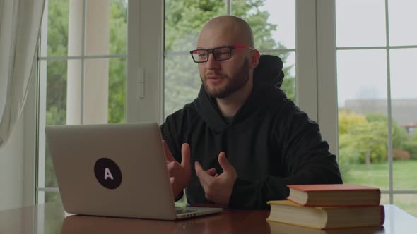 30s Man in Eye Glasses is on Video Call Using Laptop