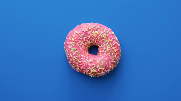 Tasty Doughnut Covered By Pink Chocolate Glaze Isolated on Blue