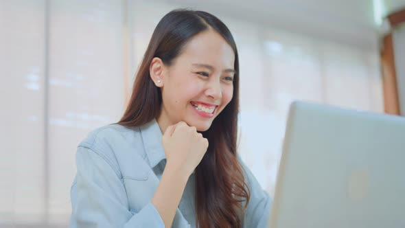 Asian excited young woman winner feel happy after looks at laptop and found out good news.