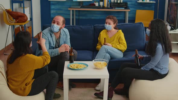 Diverse Group of Friends Celebrating with Toast Clinking Raised Bottle