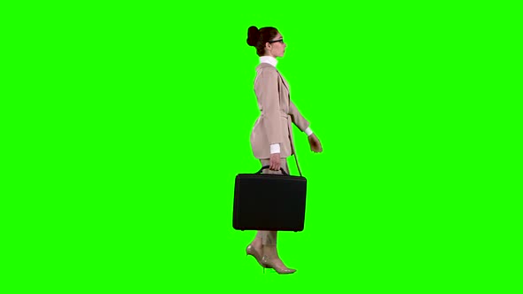 Businesswoman with Cases in His Hands Flirting Correcting Glasses. Green Screen. Side View. Slow