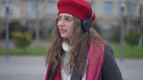 Medium Shot Portrait of Young Charming Elegant Caucasian Woman in Eyeglasses and Red Beret Enjoying