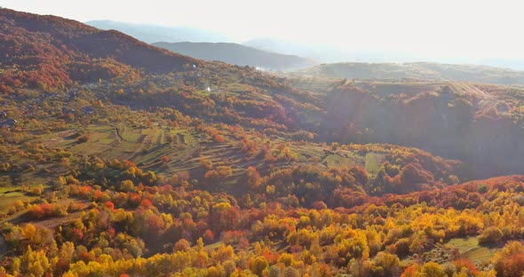 Aerial Top View the Autumn Landscape with Mountains with Small Houses in Beautiful Mountain